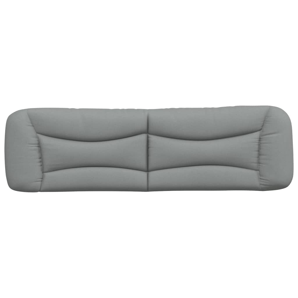 Padded grey fabric headboard with curved edges mounted above a bed