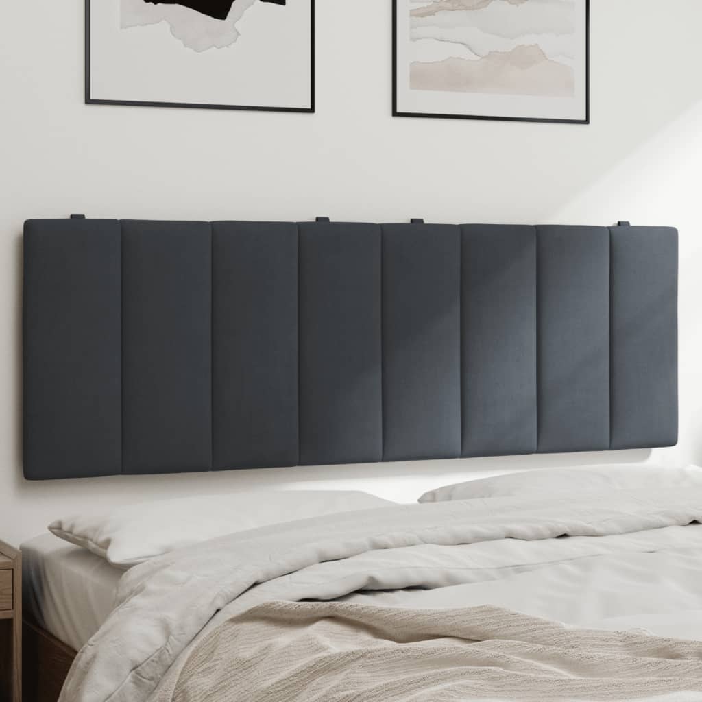Dark grey upholstered headboard with vertical paneling mounted behind a bed