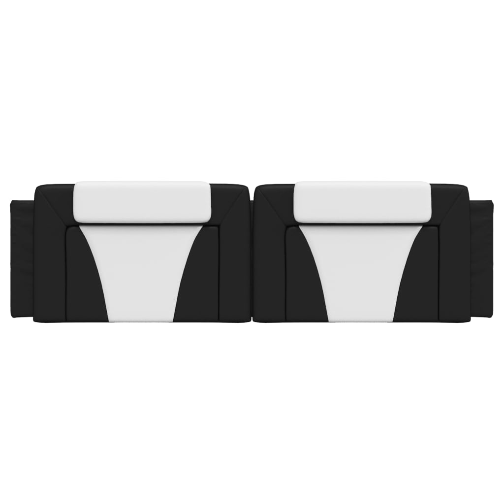 Black and white upholstered headboard panels mounted above a bed