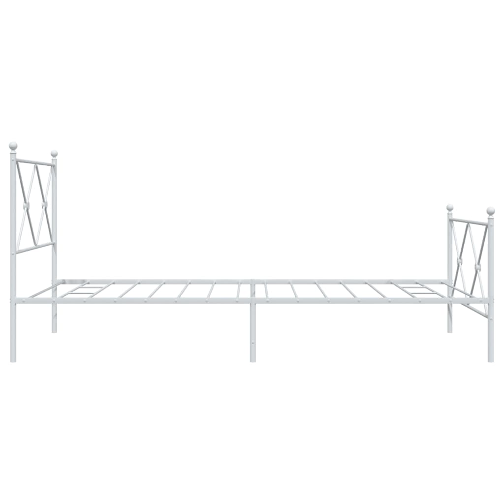 White metal bed frame with ornate scrollwork detailing and a slatted base