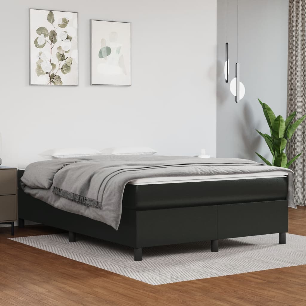 Upholstered black bed frame with grey bedding