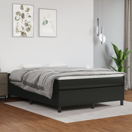 Upholstered black bed frame with grey bedding
