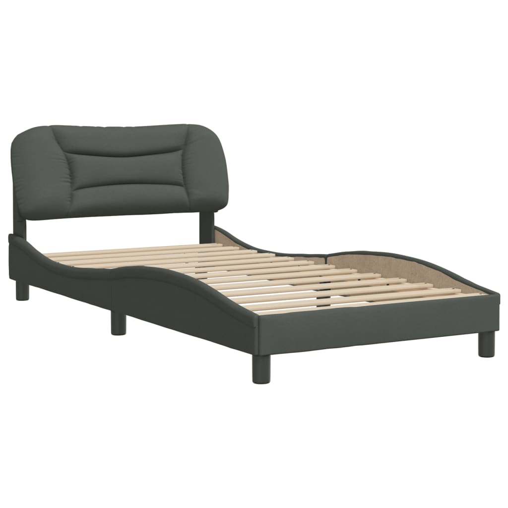 Upholstered twin bed frame in dark gray with a curved headboard and white mattress
