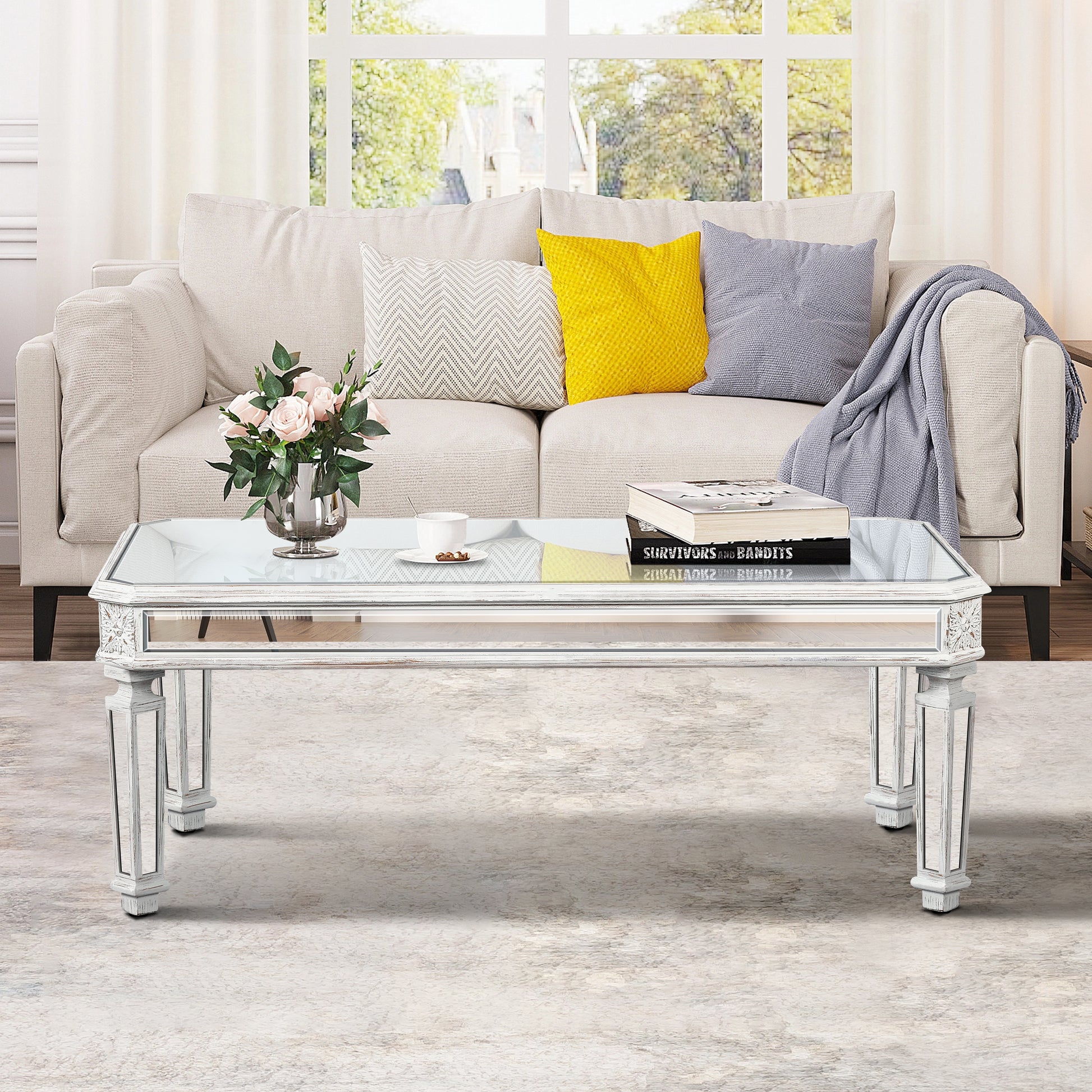 Mirrored coffee table with distressed white finish and ornate detailing