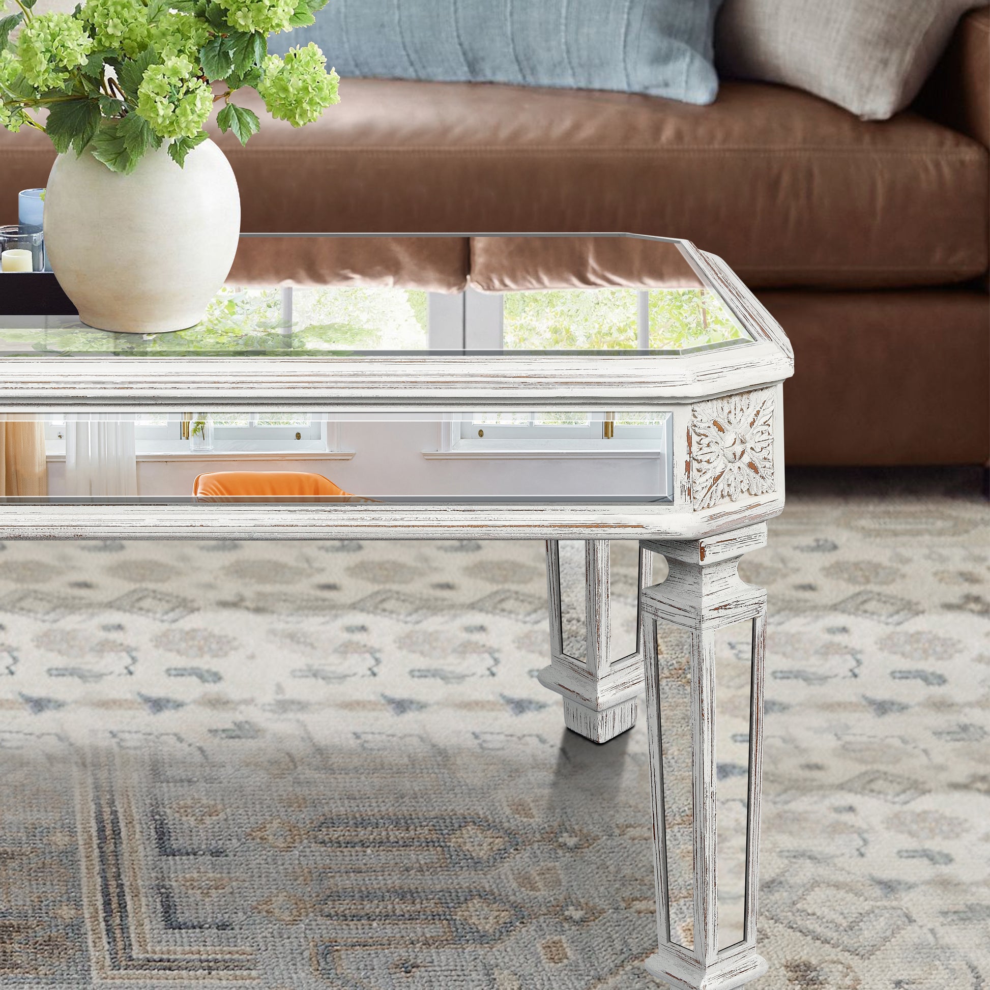 Ornate mirrored coffee table with distressed white finish and glass top