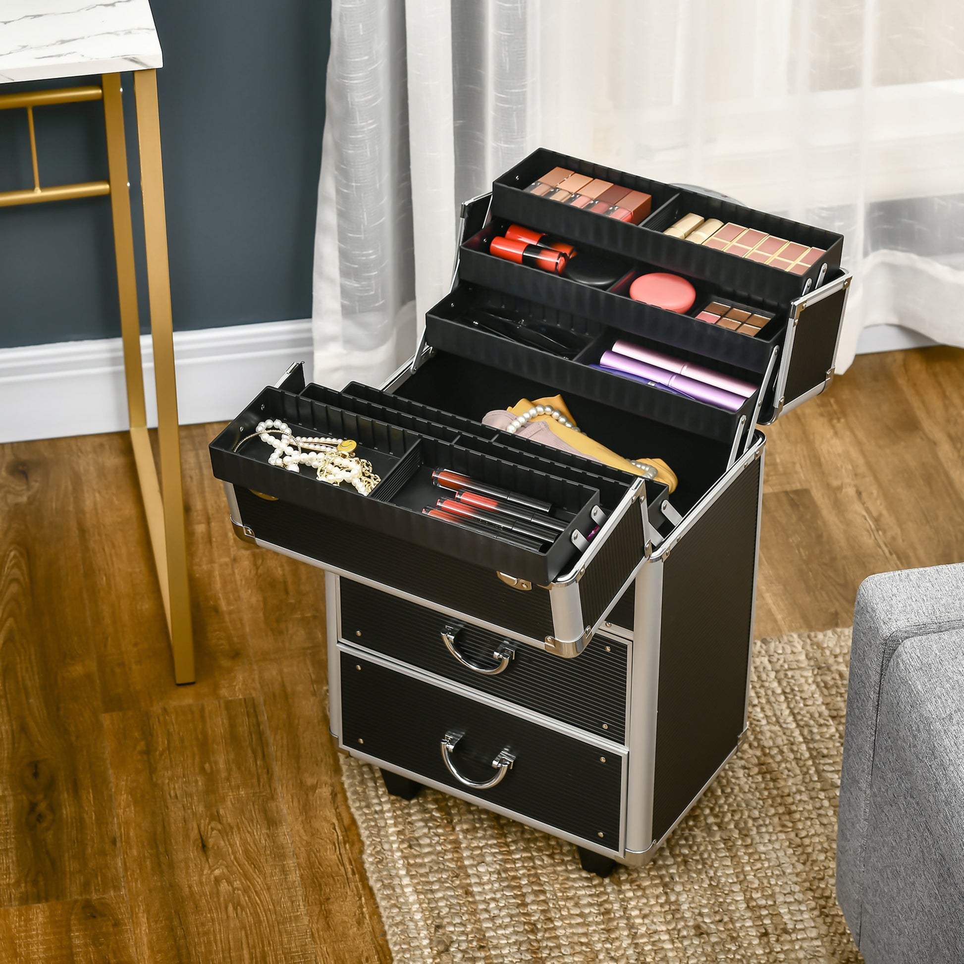 Black makeup train case with multiple compartments filled with cosmetics