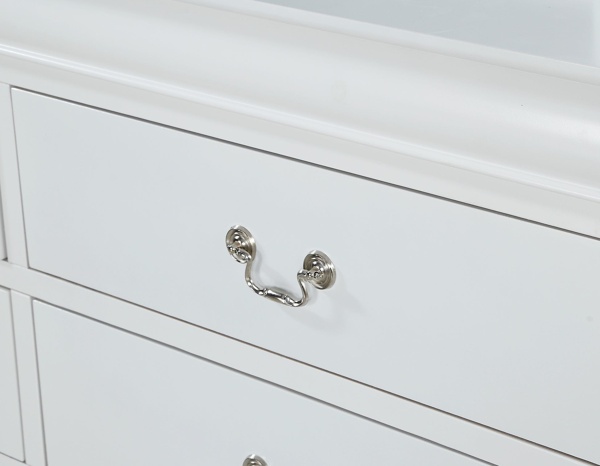White wooden dresser with ornate silver drawer pull