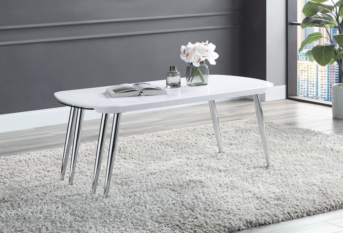 White modern coffee table with chrome legs on fluffy rug