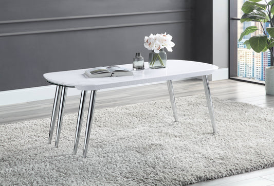 White modern coffee table with chrome legs on fluffy rug