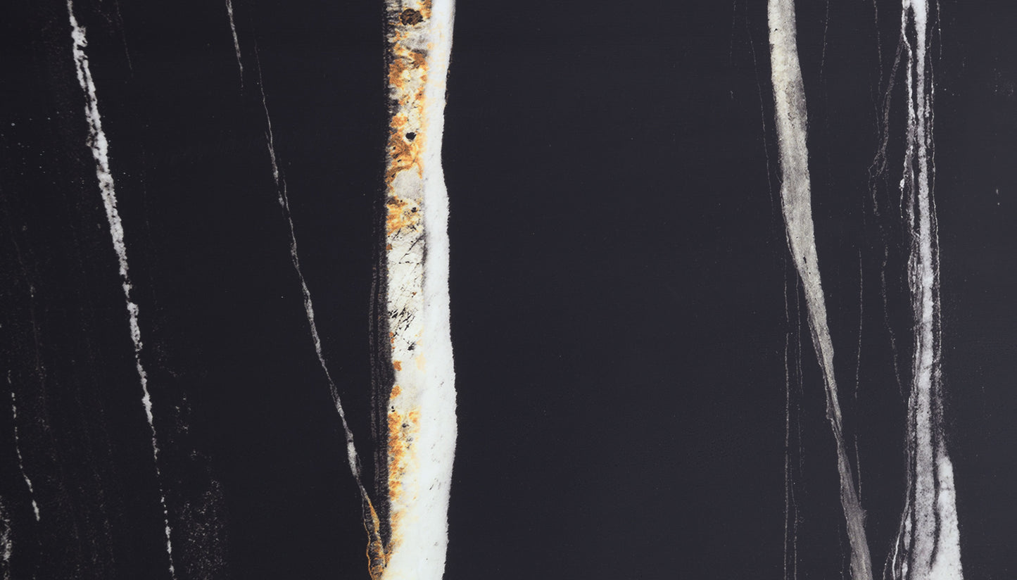 Black marble slab with abstract white and gold veining