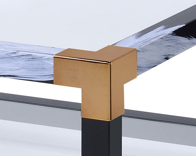 Gold corner bracket on a black metal table leg