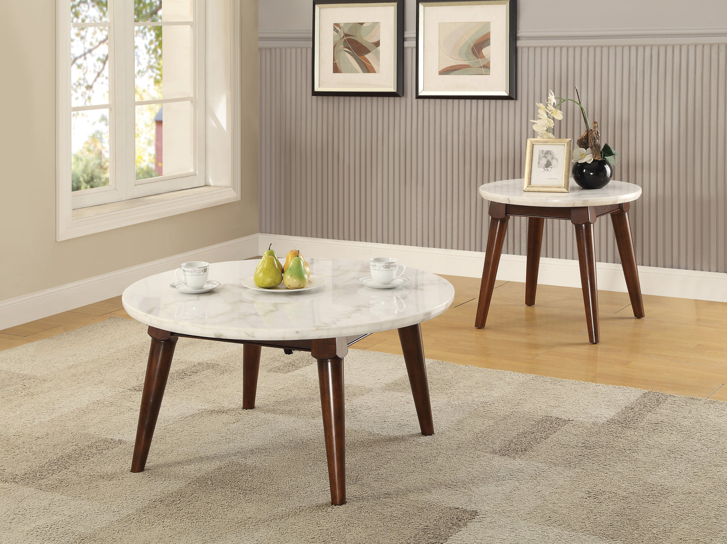 White marble coffee table with dark wood legs and two cups