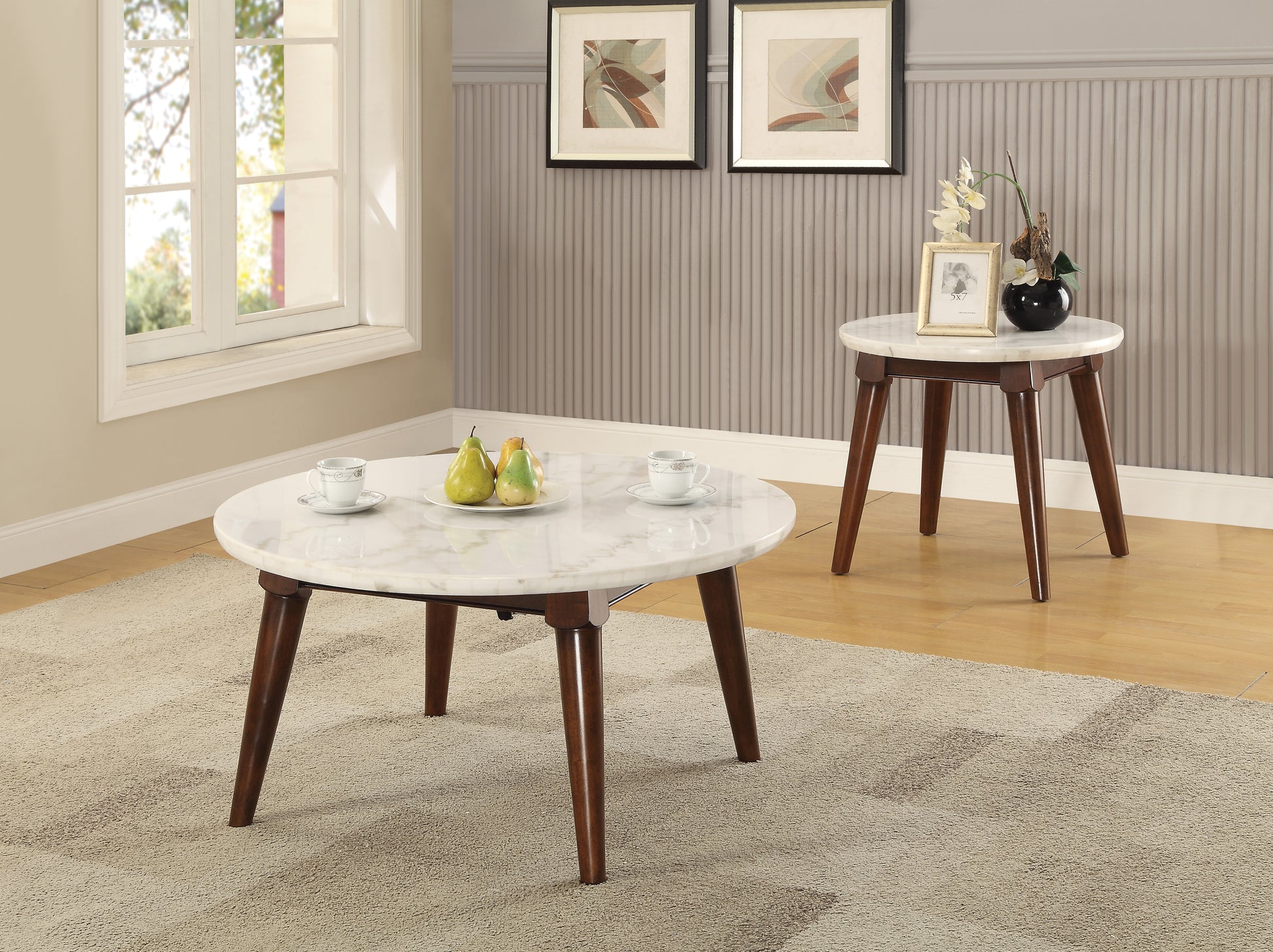 White marble coffee table with dark wood legs and two cups