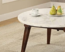 Round white marble coffee table with dark wood tapered legs