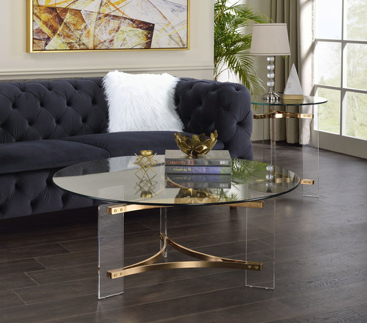 Modern oval glass coffee table with gold accents and clear acrylic legs