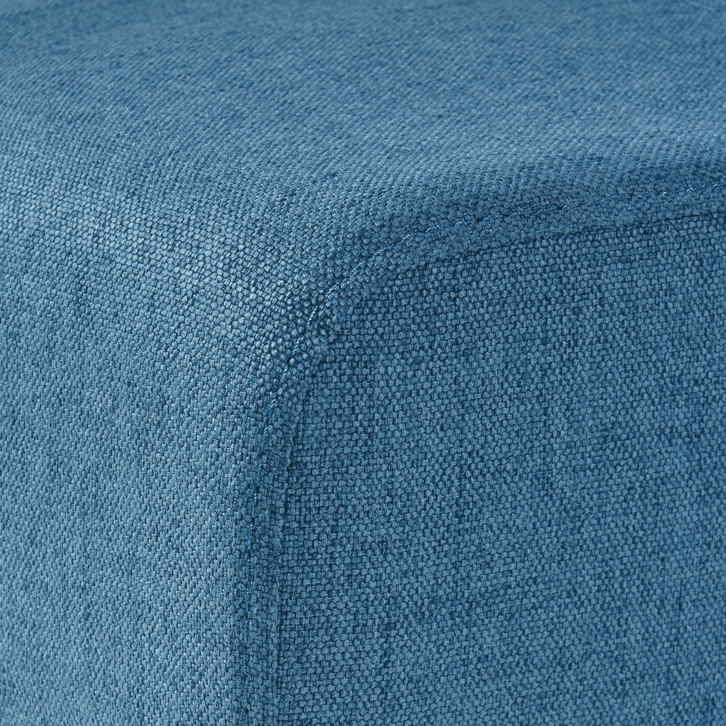 Textured blue fabric ottoman corner detail