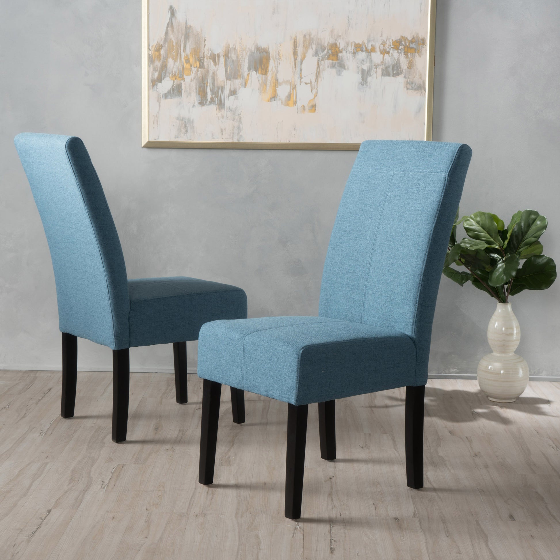 Two light blue upholstered dining chairs with dark wood legs
