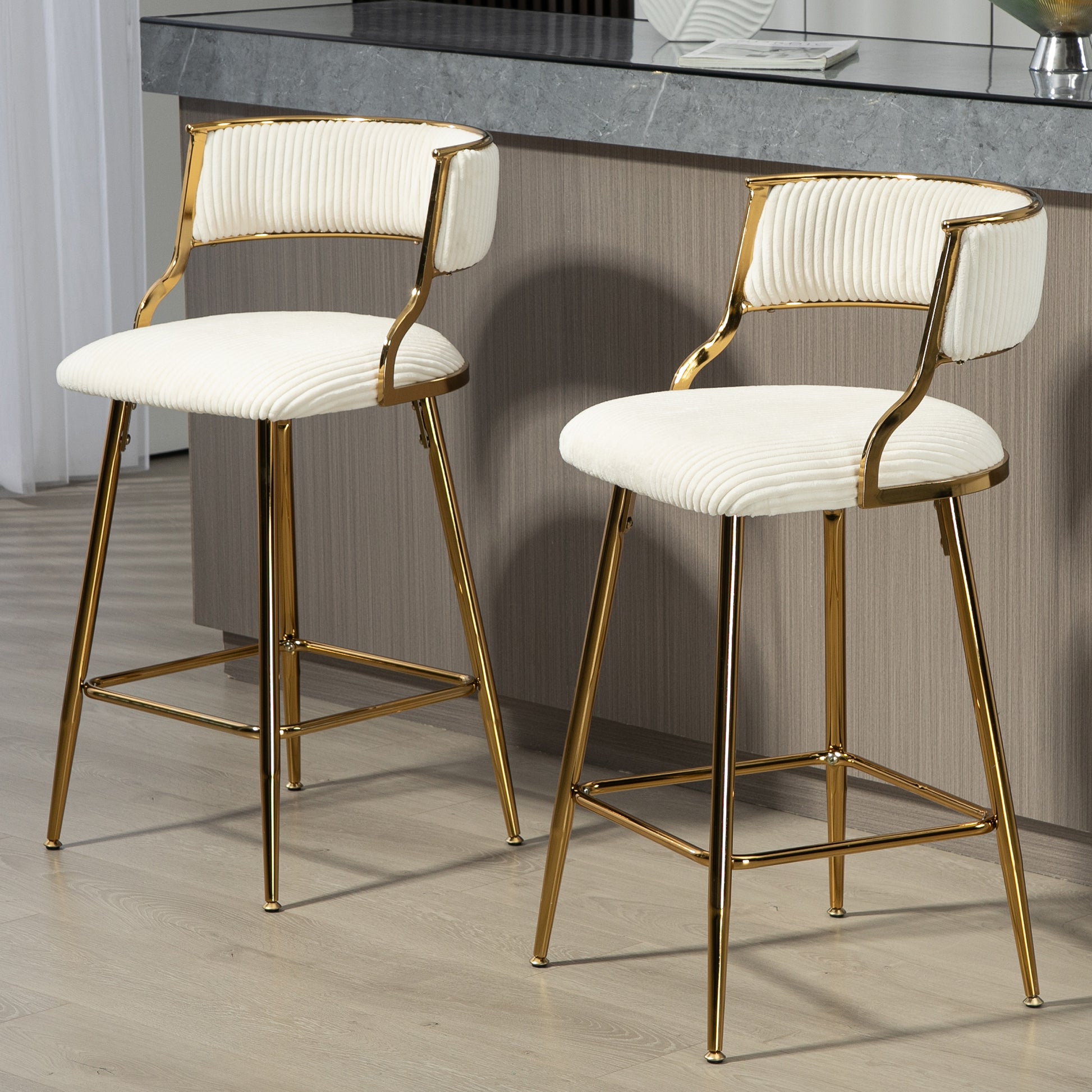 Cream upholstered bar stool with gold legs and ribbed texture
