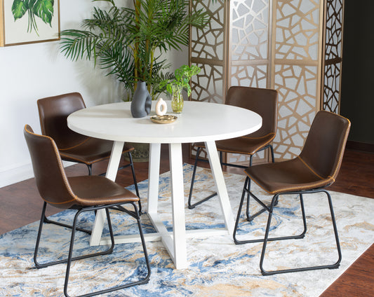 White round dining table with four brown leather chairs