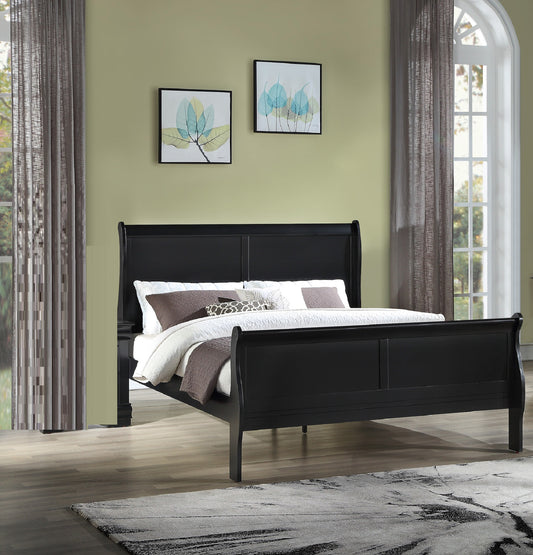 Black sleigh bed with plush bedding and decorative pillows