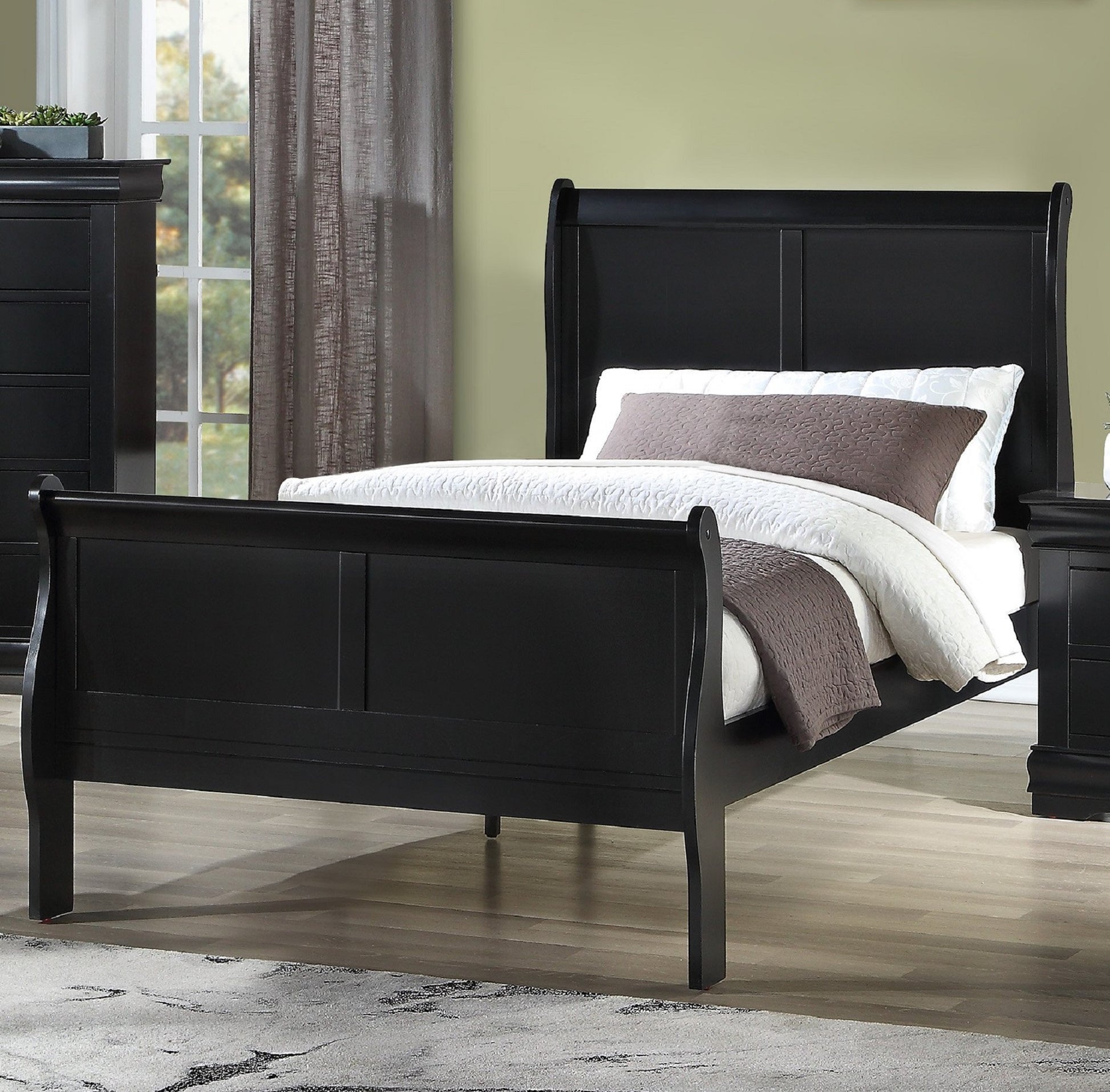 Black wooden sleigh bed with upholstered headboard and textured bedding