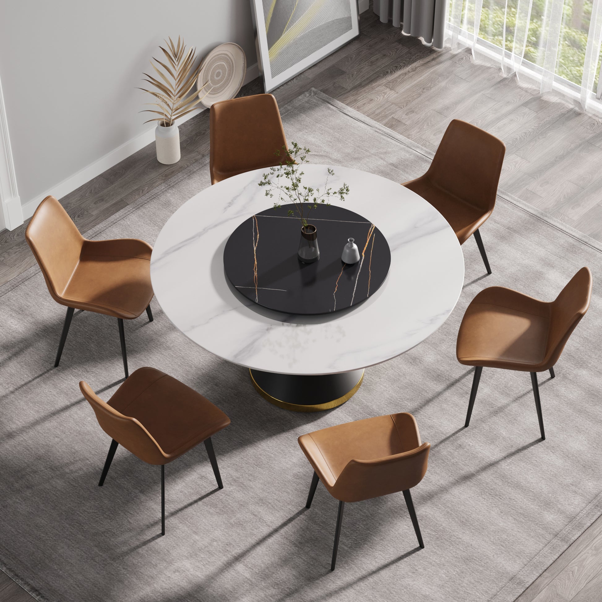 Round white marble dining table with black pedestal base and tan leather chairs