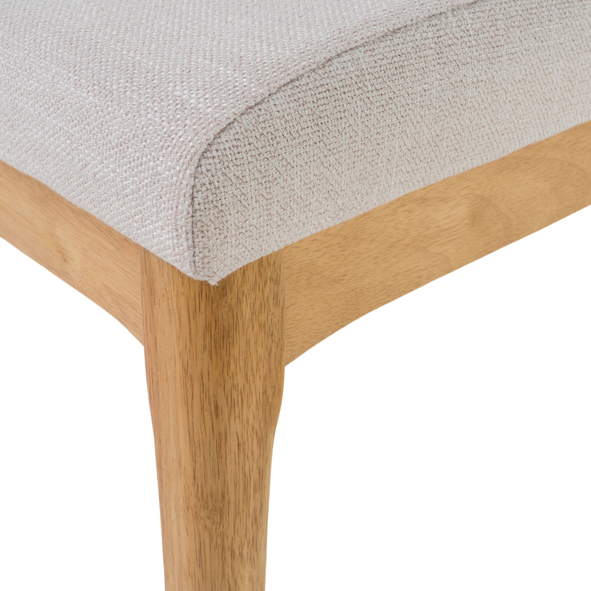 Closeup of light beige woven fabric seat with visible texture on wooden chair leg