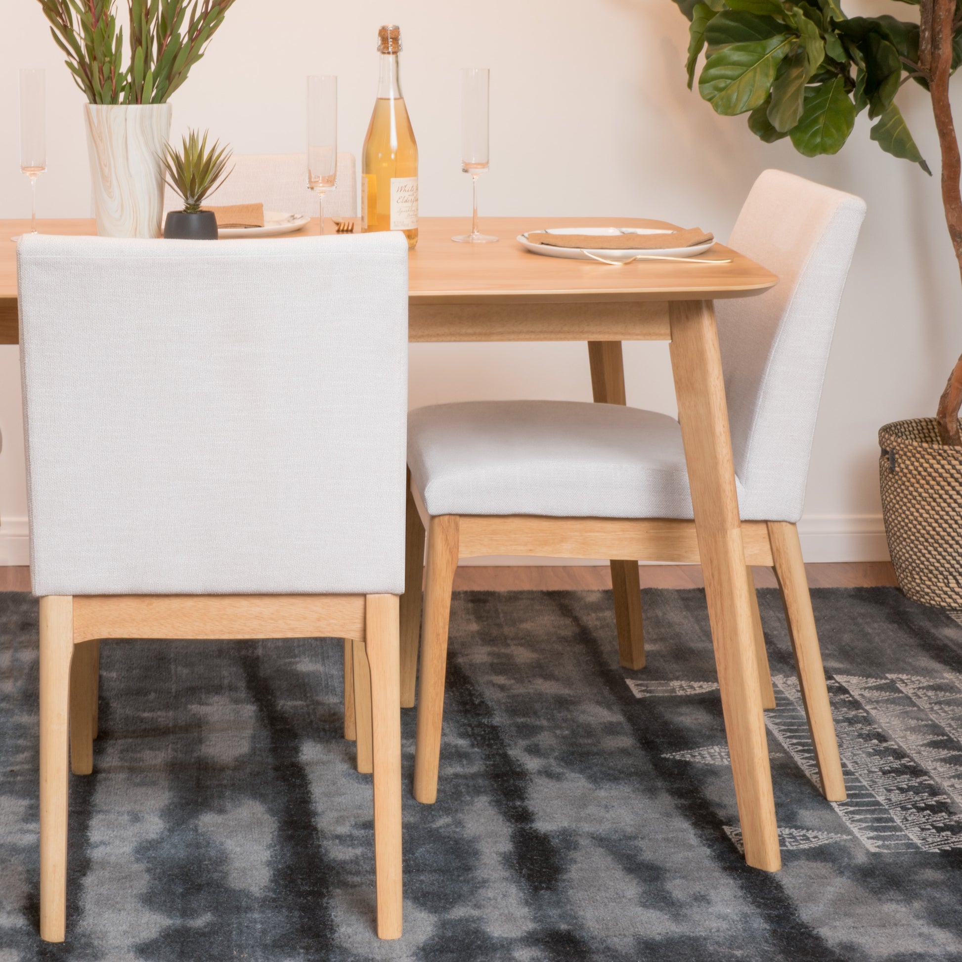Light gray upholstered dining chair with natural wood legs