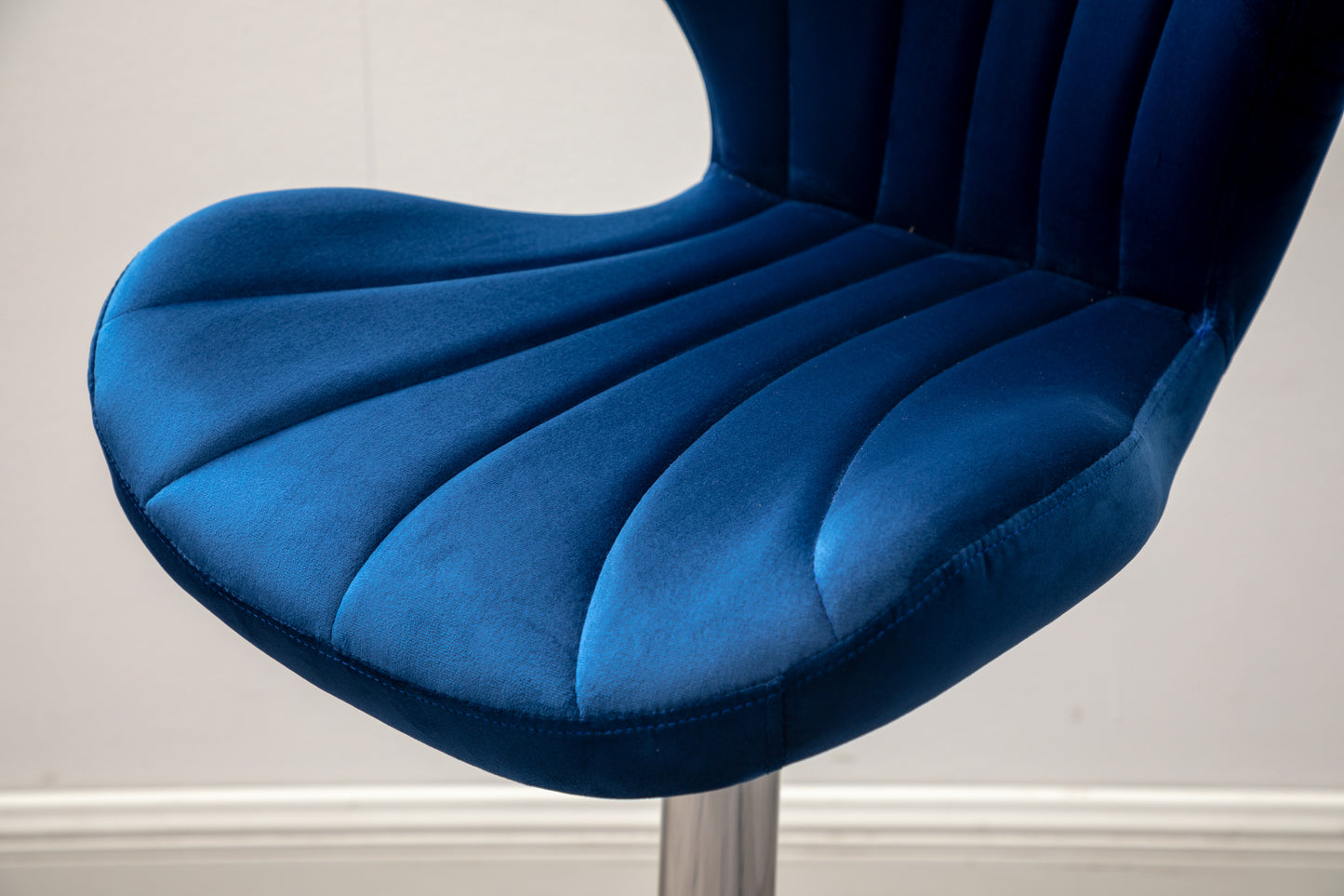 Deep blue velvet bar stool seat with vertical tufting