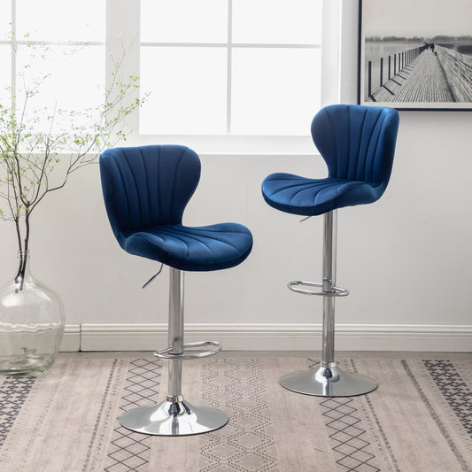 Two plush navy blue velvet bar stools with chrome bases