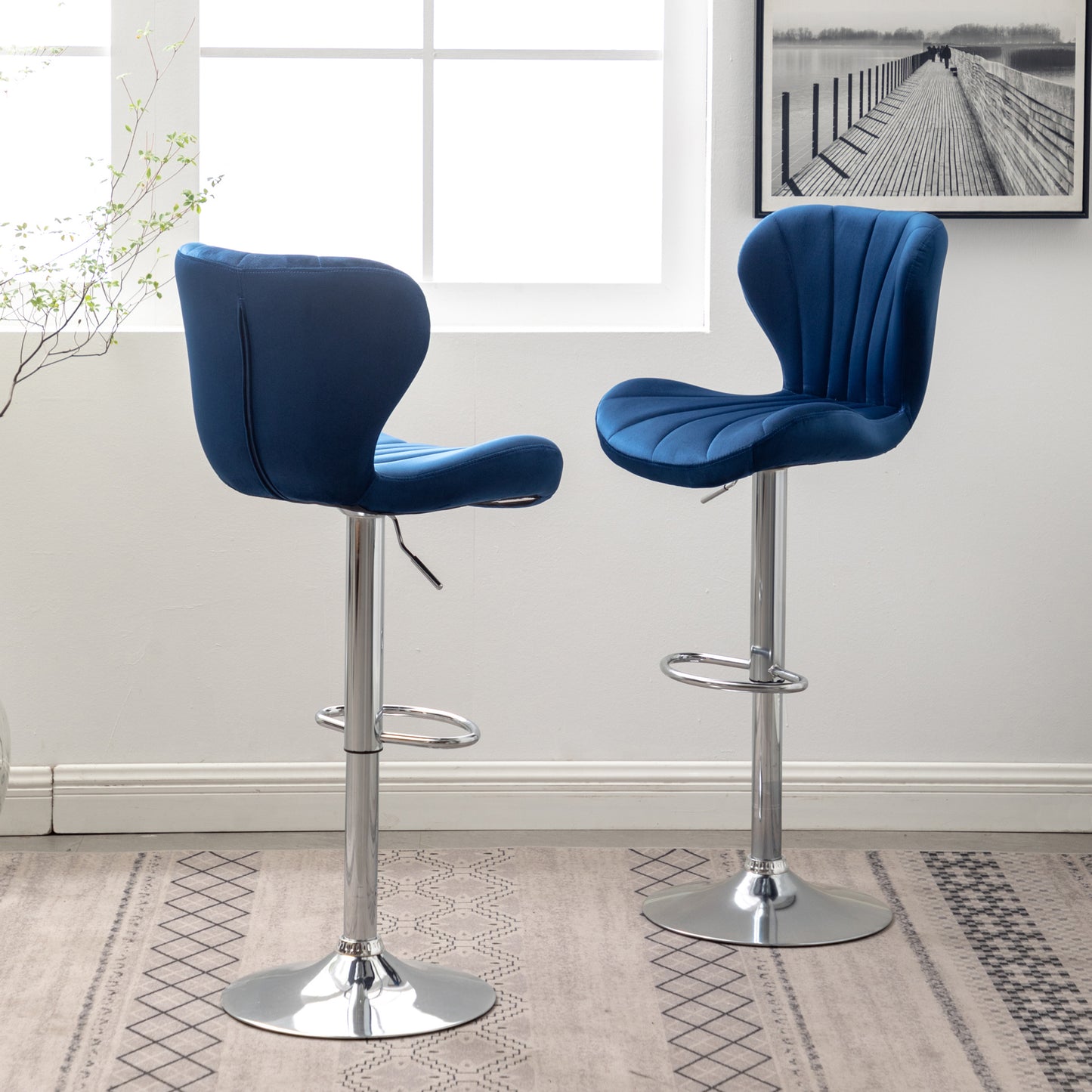 Deep blue velvet bar stool with tufted back and chrome base