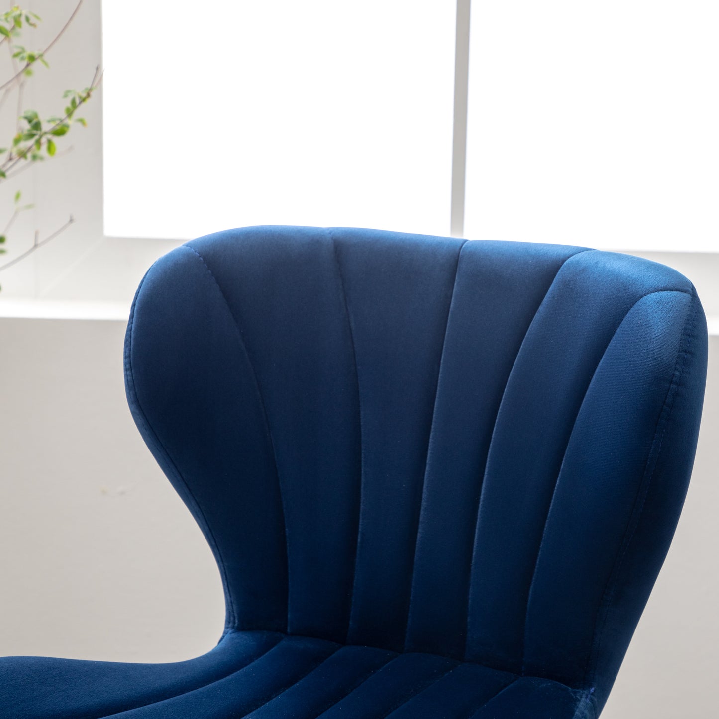 Deep blue velvet dining chair with channel tufting