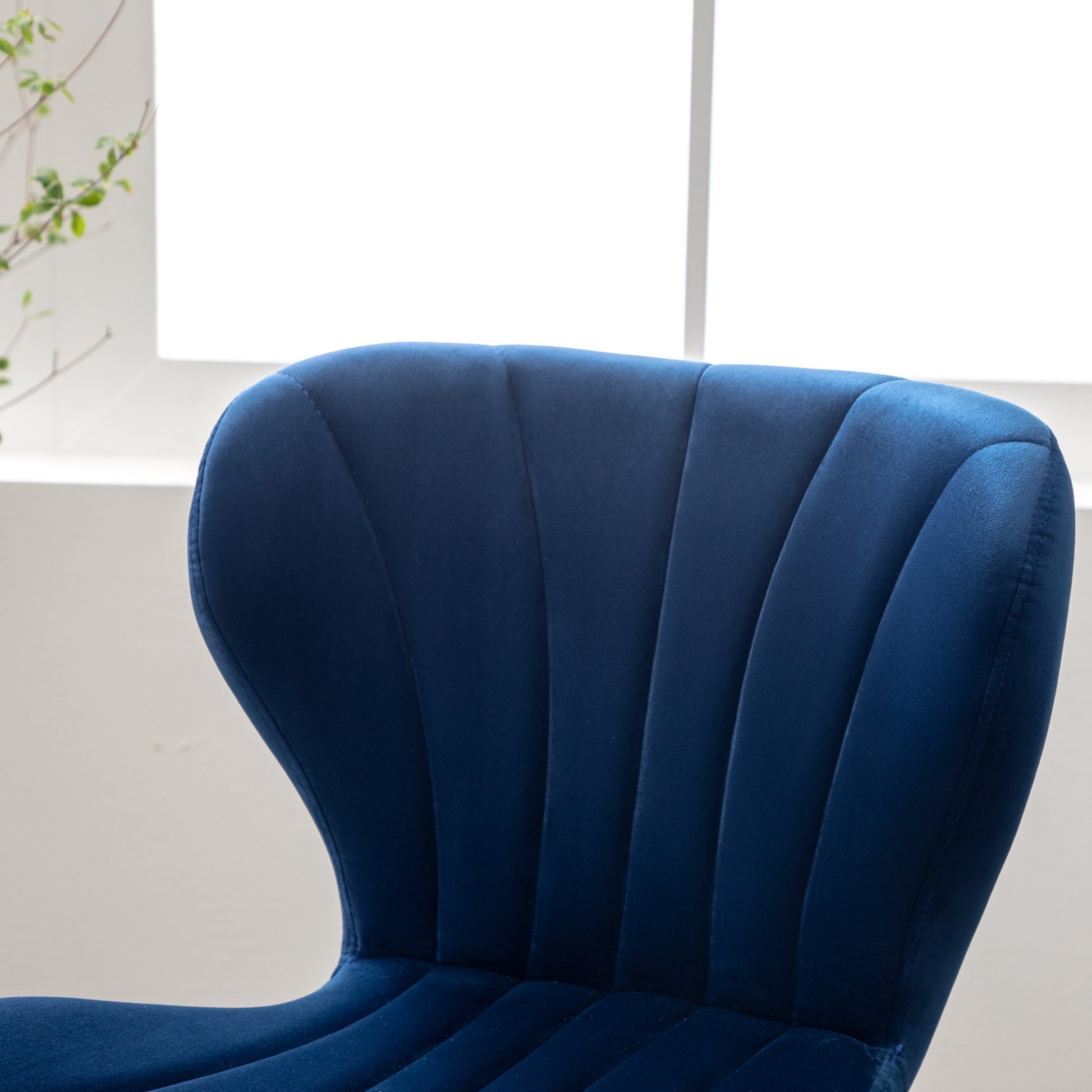 Deep blue velvet dining chair with channel tufting