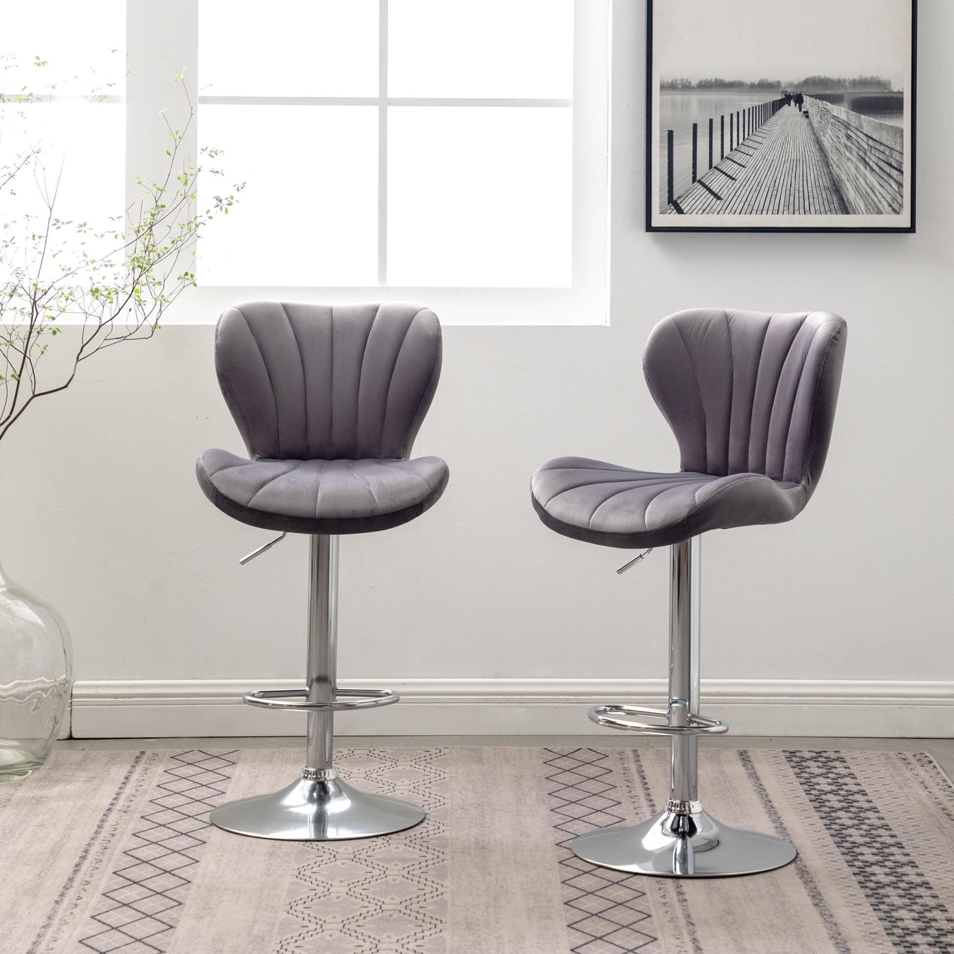 Two grey velvet bar stools with chrome bases