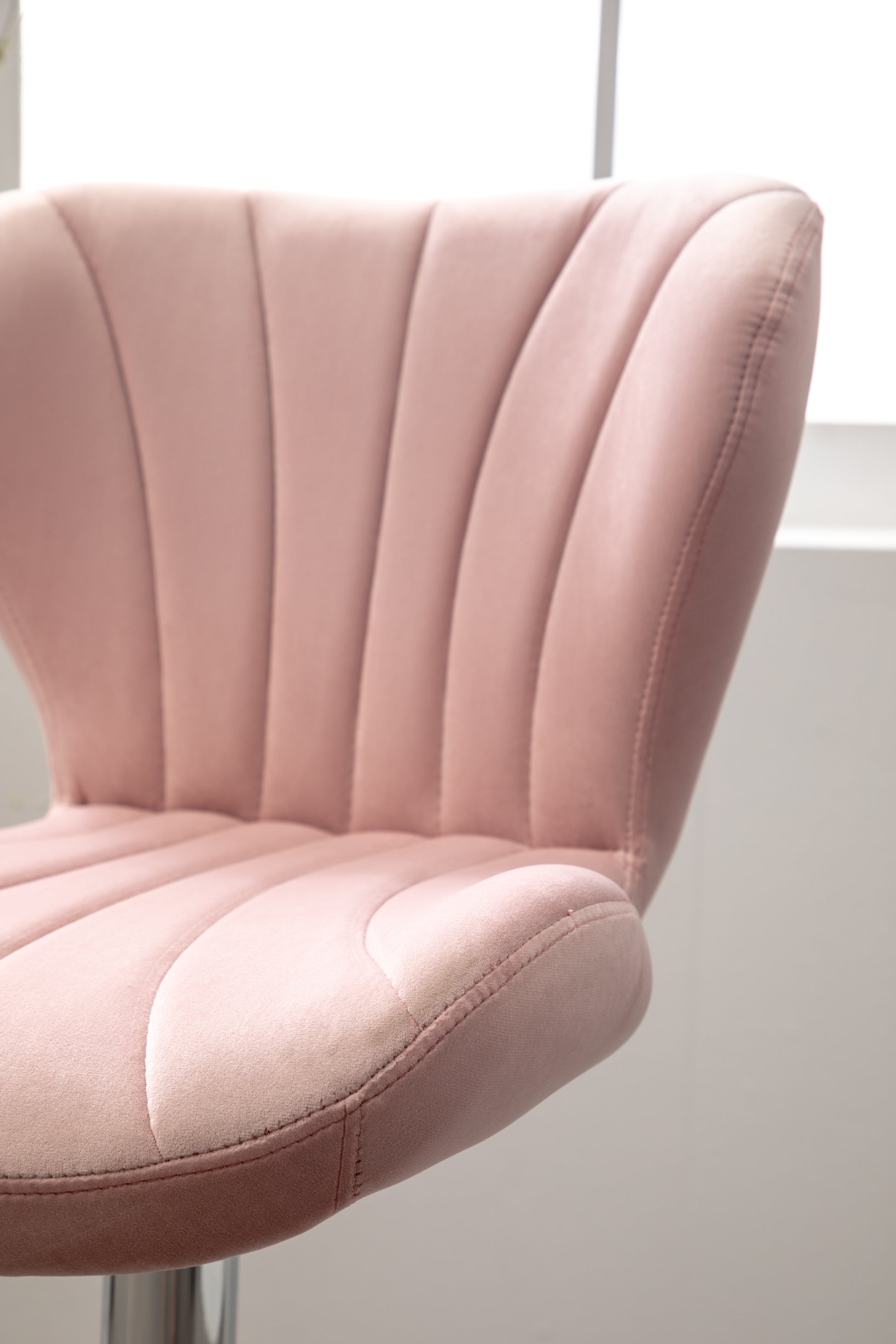 Dusty rose velvet accent chair with channel tufting and curved backrest
