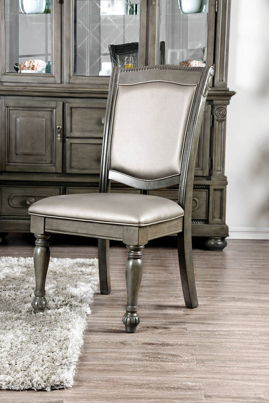 Gray upholstered dining chair with carved wood legs