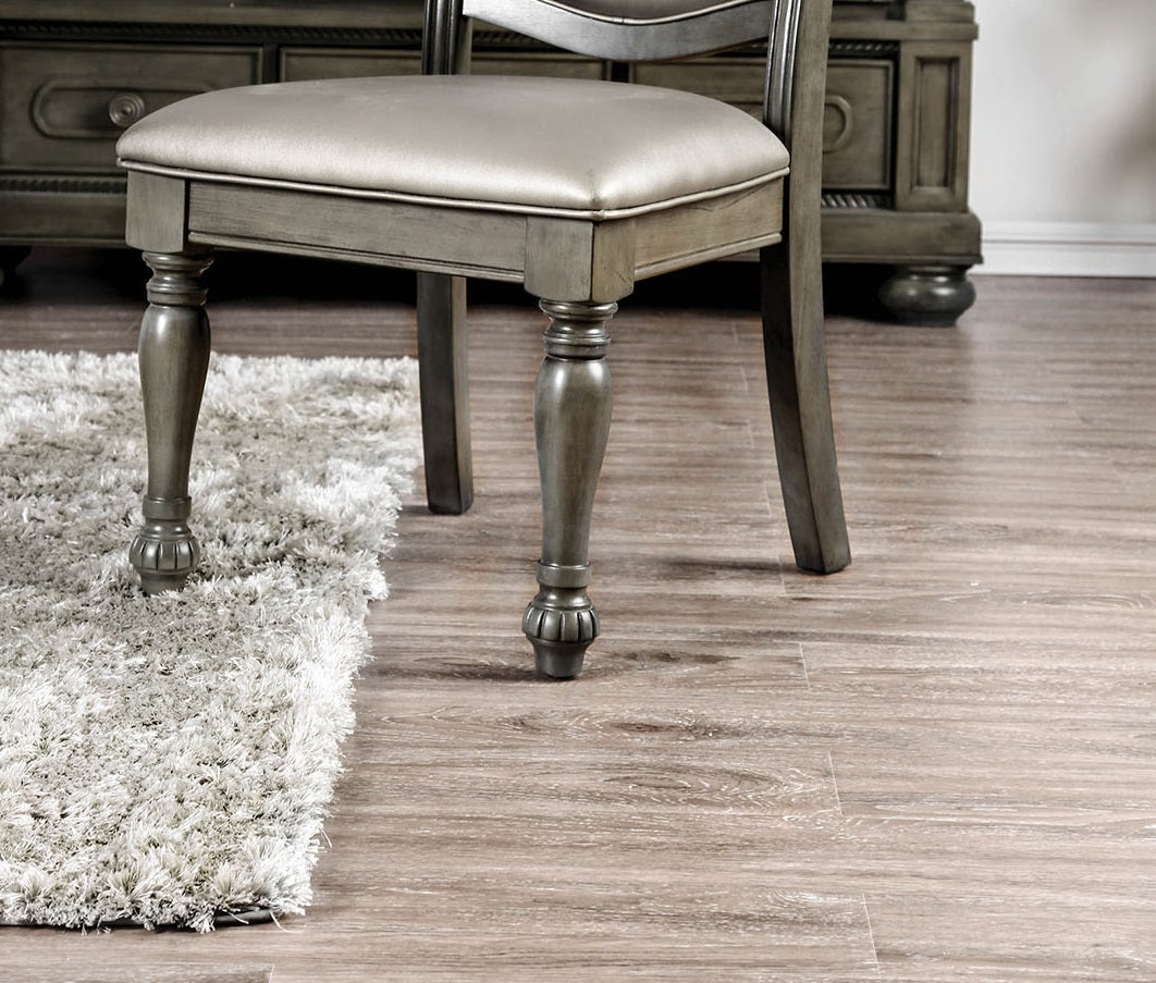 Gray upholstered dining chair with carved wooden legs