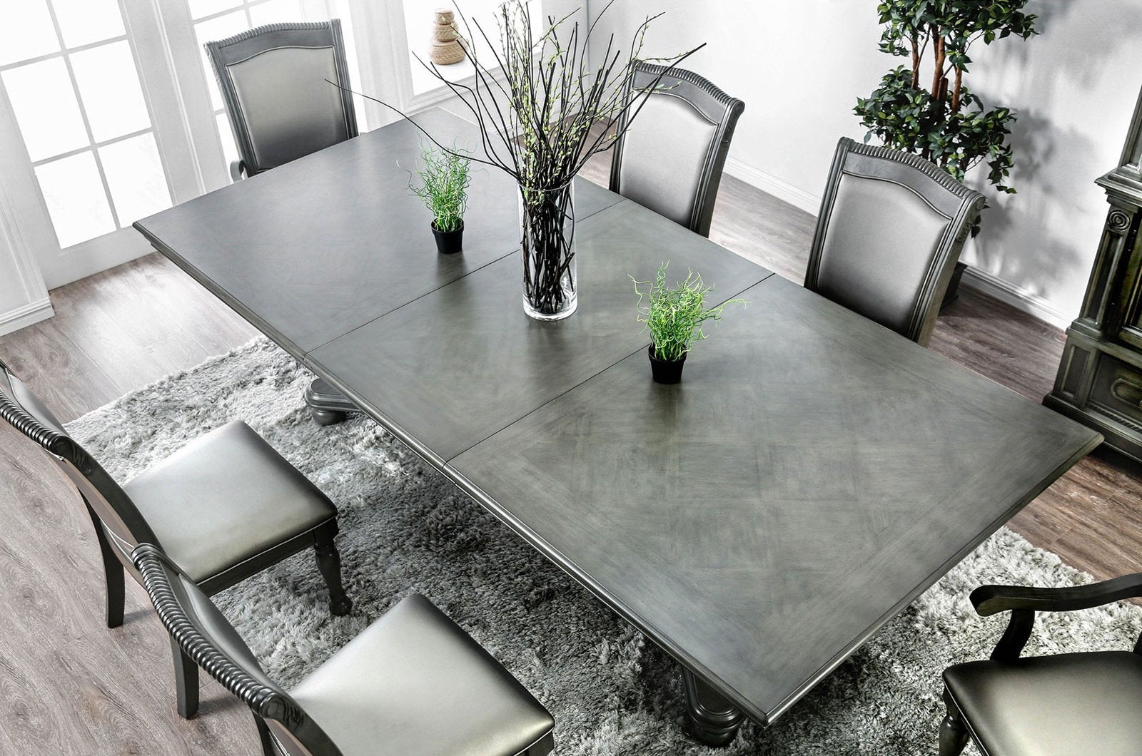 Elegant grey wooden dining table with ornate chairs