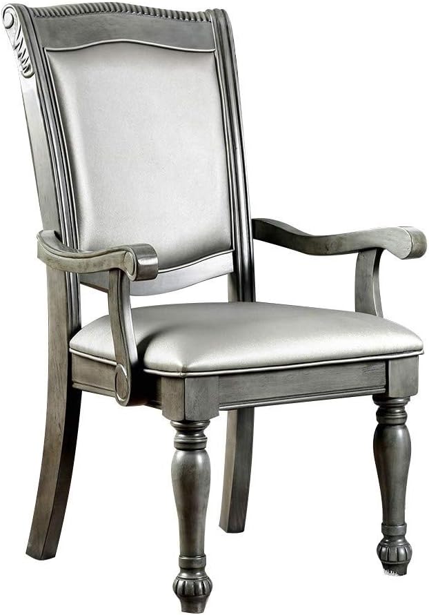 Gray upholstered arm chair with carved wooden frame and turned legs