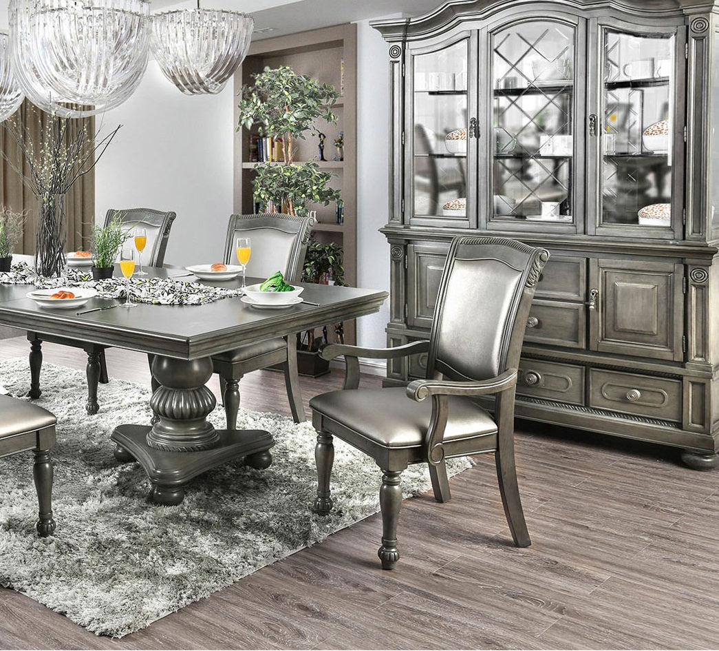 Ornate grey upholstered dining chair with carved details
