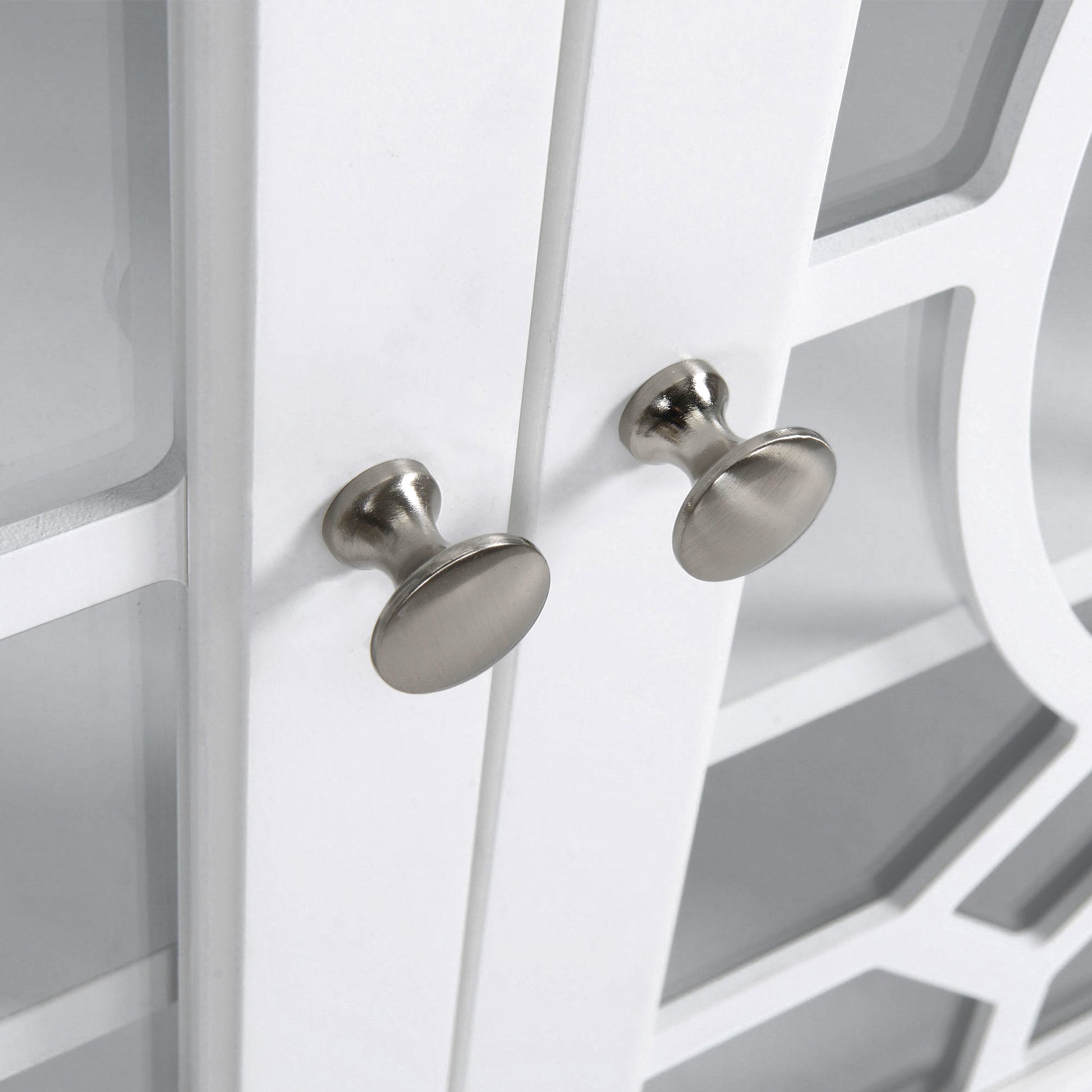 White cabinet with brushed nickel knobs and lattice detail