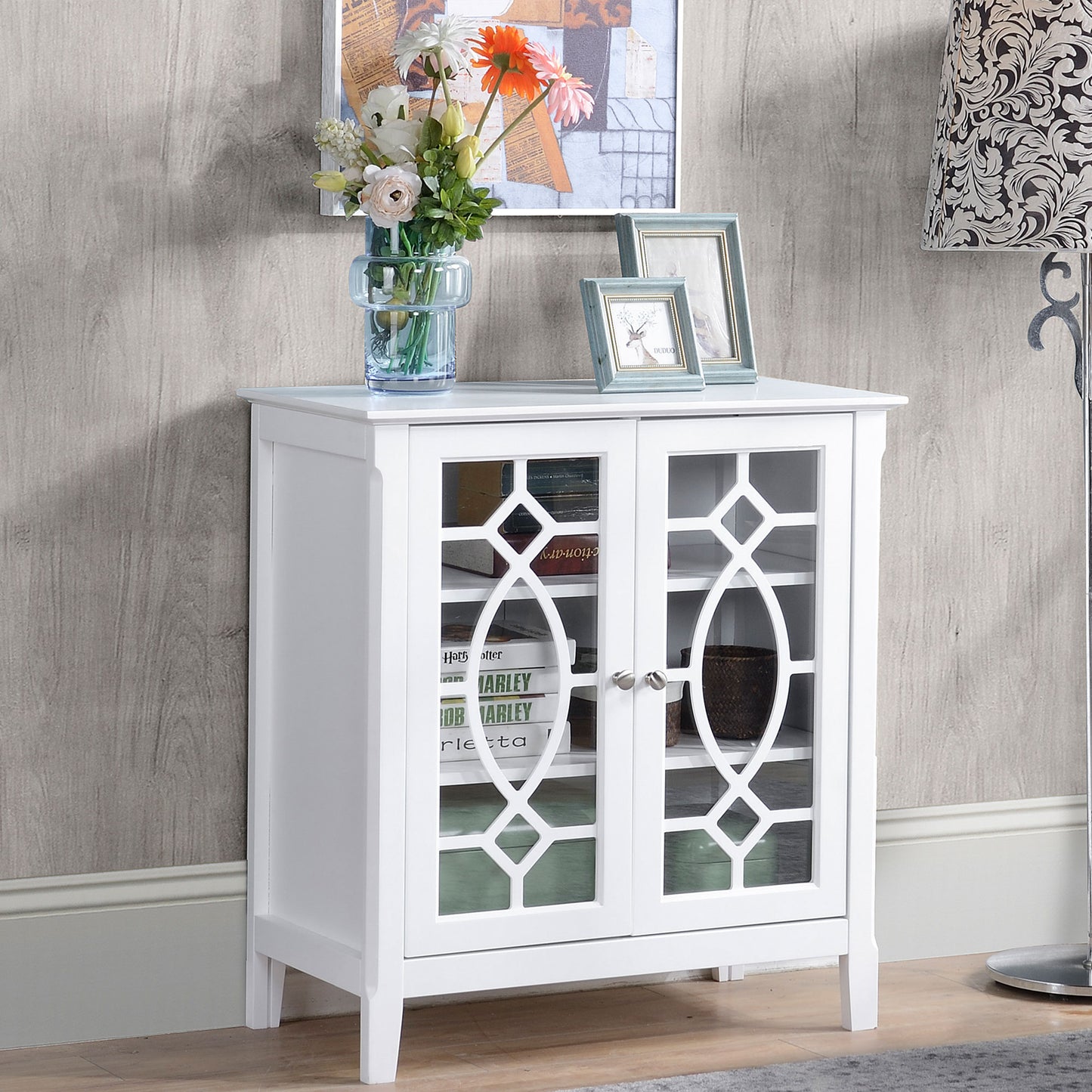 White cabinet with decorative glass doors and metal knobs