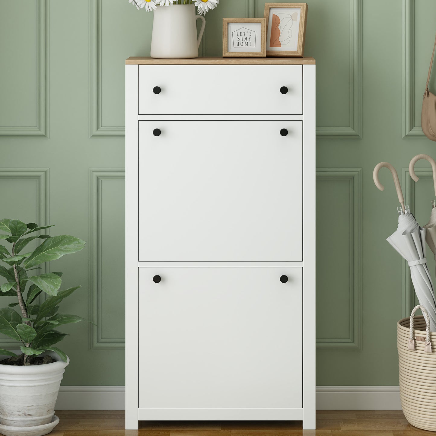 White entryway shoe cabinet with oak wood top and black knobs