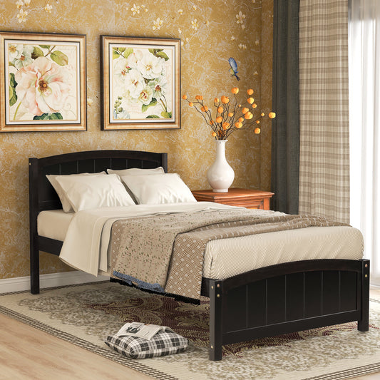Dark wood arched headboard bed frame with white linens