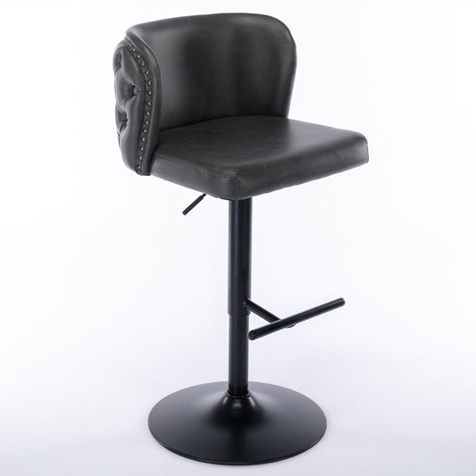Dark grey faux leather bar stool with tufted back and brass nailhead trim