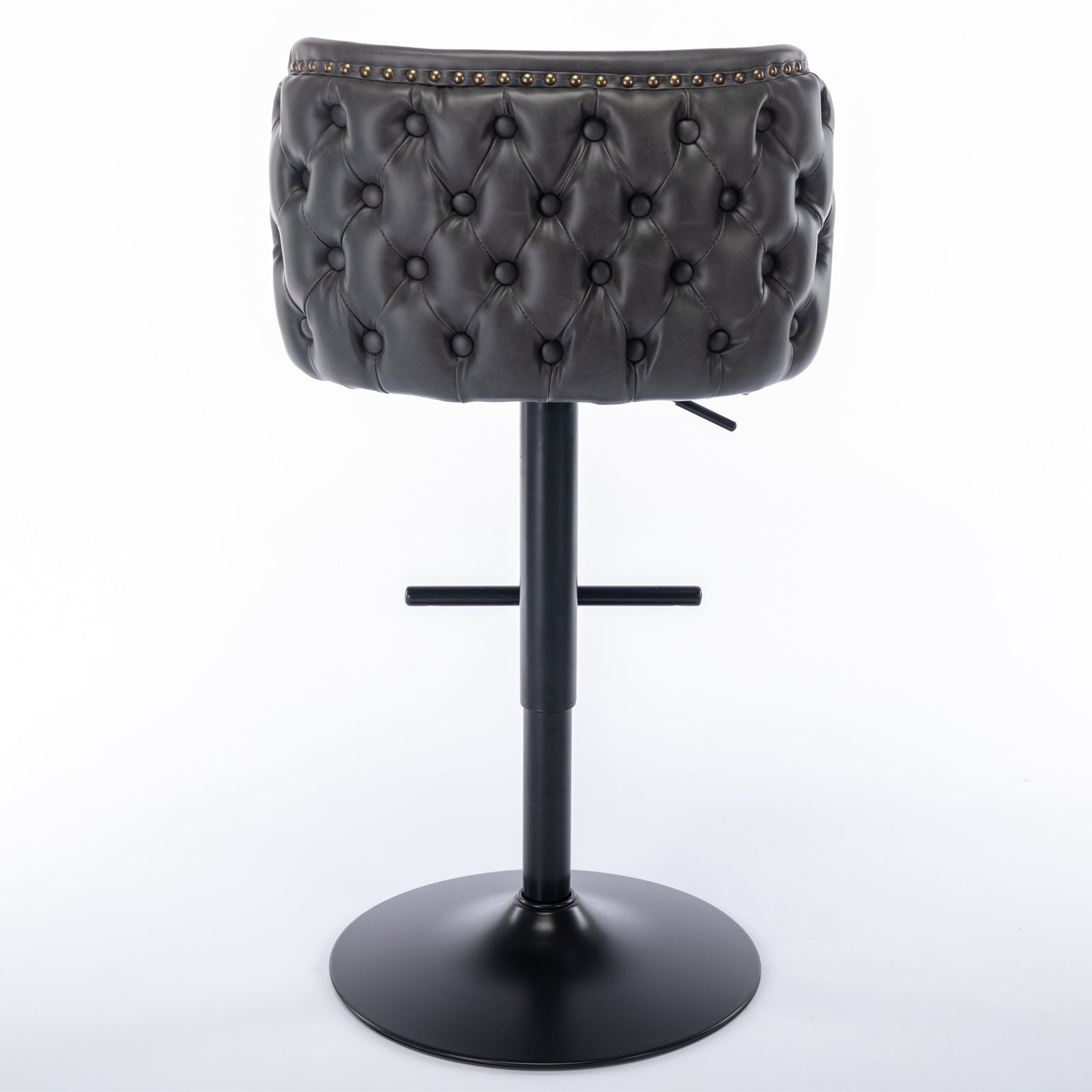 Dark gray tufted leatherette bar stool with brass nailhead trim and black adjustable base