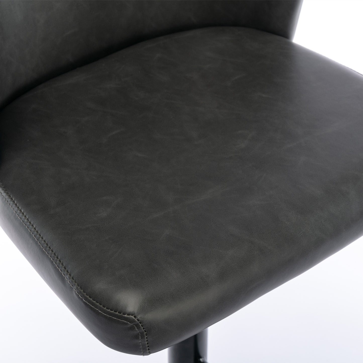 Dark gray faux leather chair seat detail with visible stitching and distressed texture