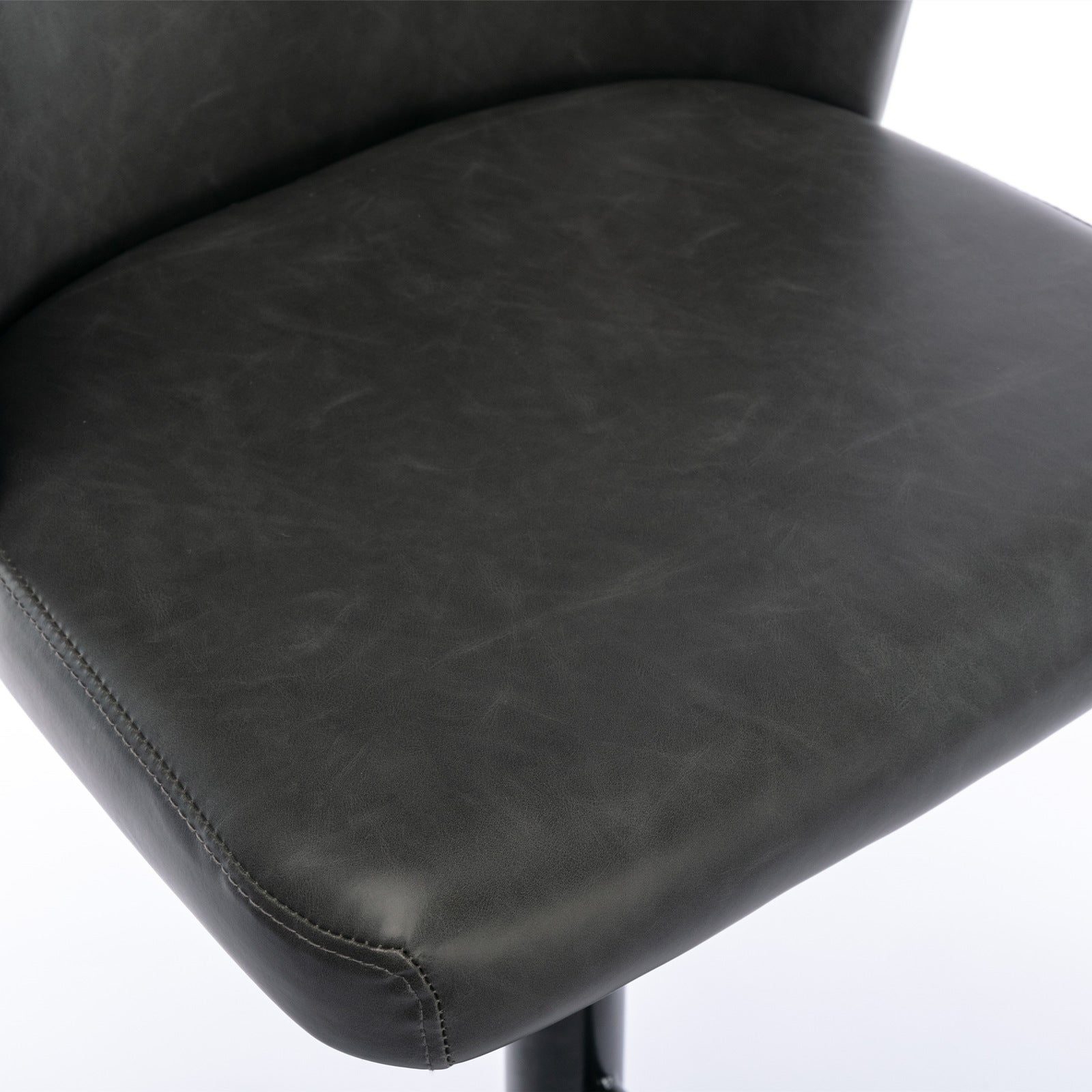 Dark gray faux leather chair seat detail with visible stitching and distressed texture