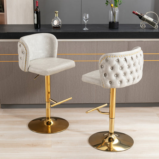 Light gray tufted bar stool with gold base and nailhead trim
