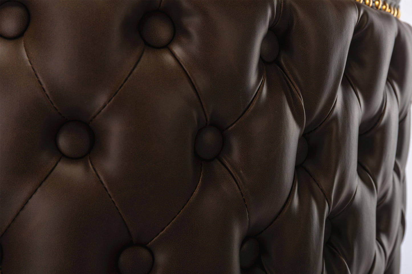 Brown tufted leather upholstery detail with diamond stitching